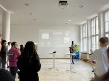 A woman speaks in front of students. 